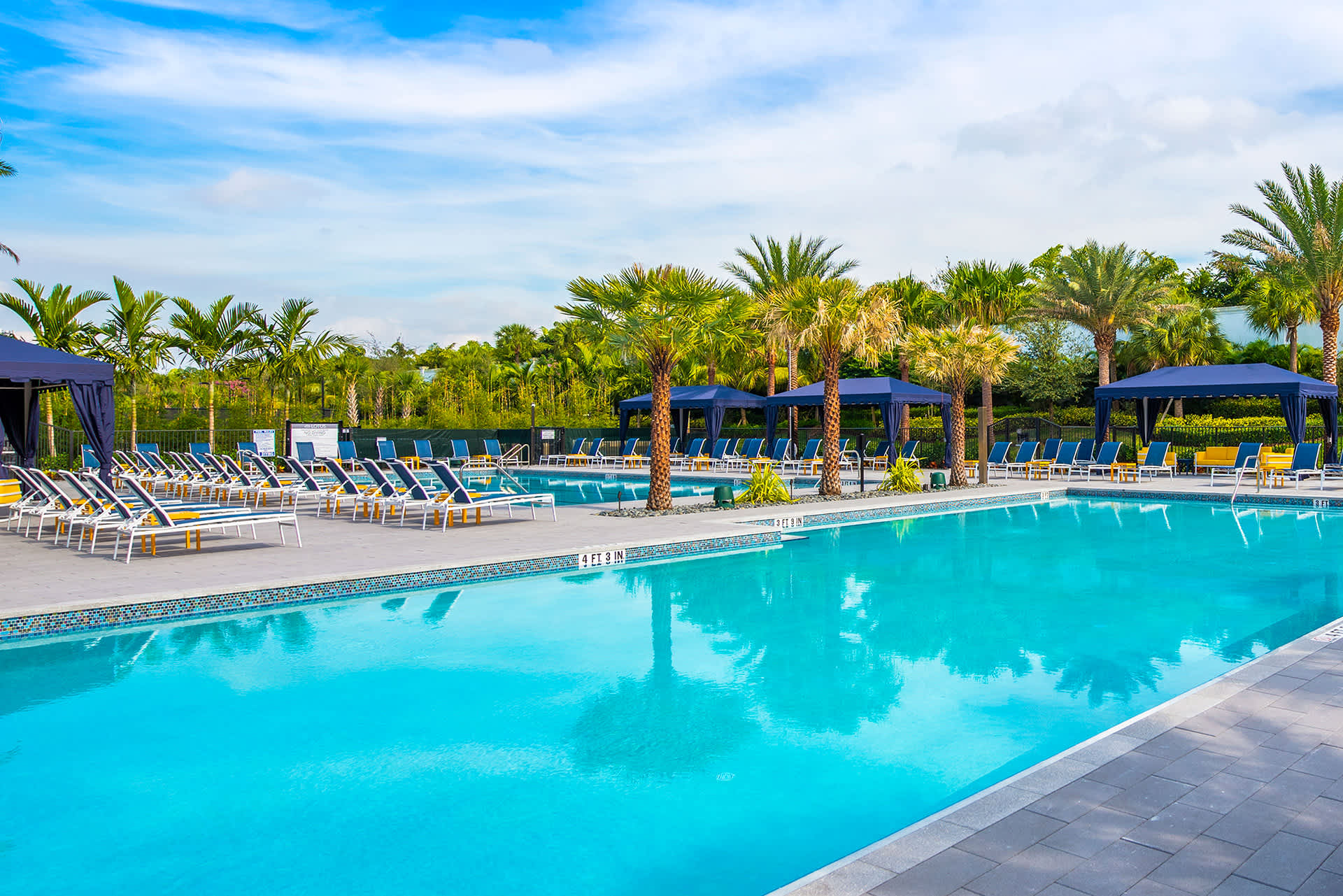 Pool with pool chairs around it