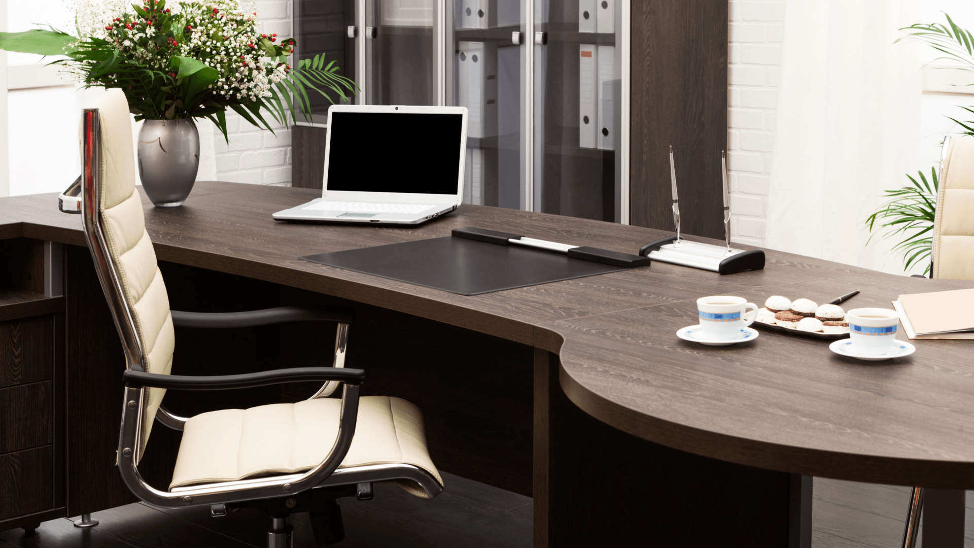 Laptop and flowers on the table in a modern office
