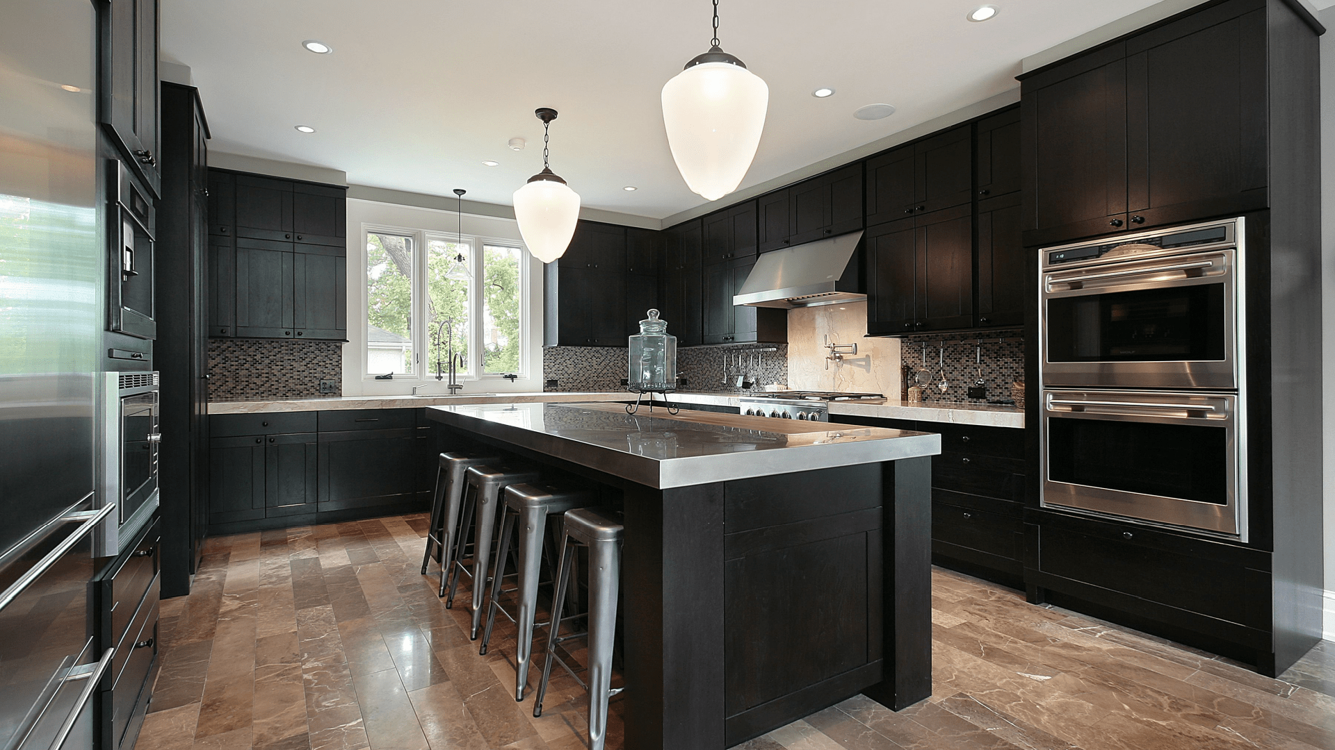 Kitchen in luxury home with dark wood cabinetry